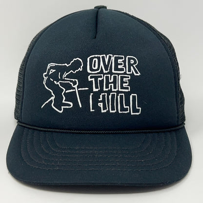 Vintage trucker cap in black featuring 'Over The Hill' design, front view