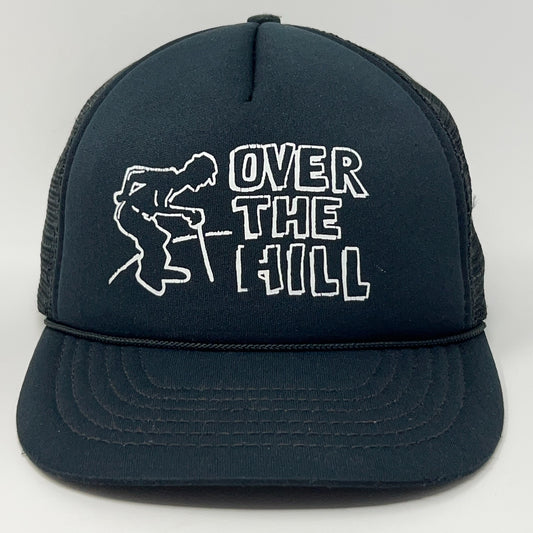 Vintage trucker cap in black featuring 'Over The Hill' design, front view
