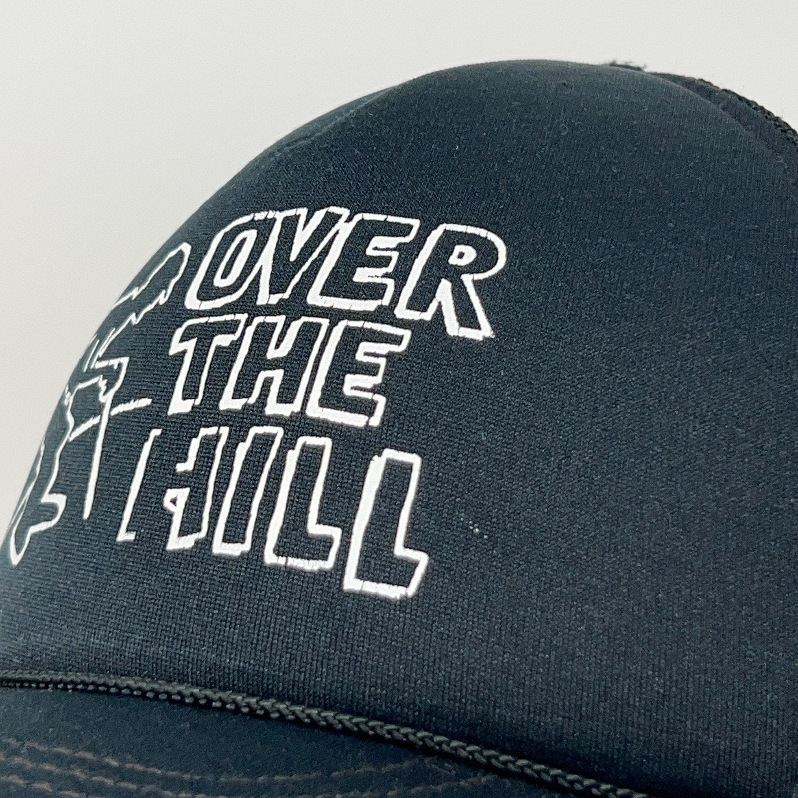 Vintage trucker cap black front view with 'Over the Hill' graphic