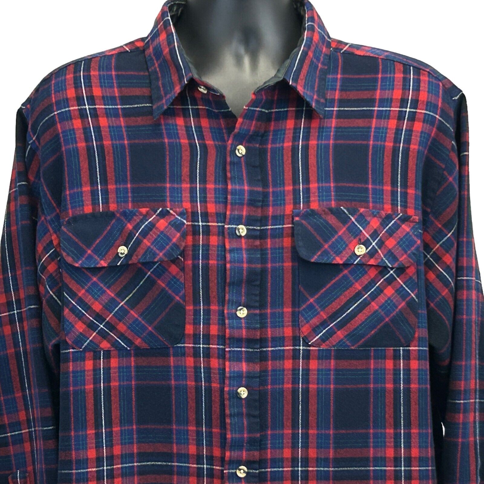 Vintage plaid shirt in navy and red featuring two front pockets and a classic fit