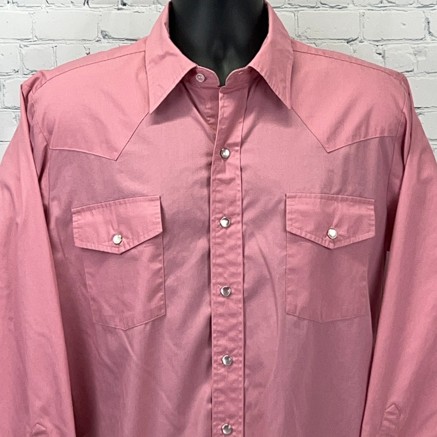 Front view of Malco Modes Western Shirt in pink, featuring classic snap buttons and dual chest pockets