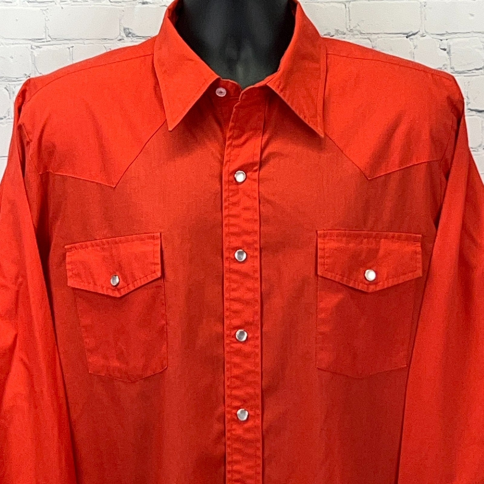 Front view of red Malco Modes Western Shirt featuring snap button closures and two chest pockets