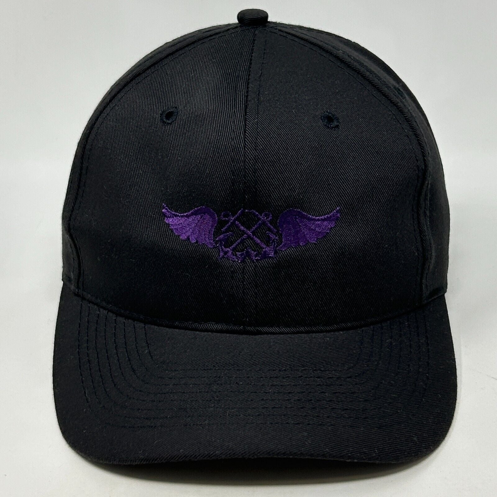 Black Otto Hat with Embroidered Purple Wings and Two Anchors Logo on Front View
