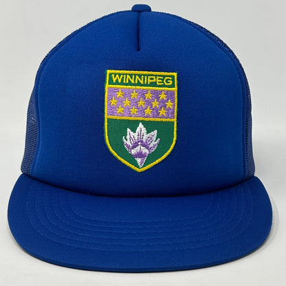 Front view of a blue Winnipeg Hat featuring an embroidered logo with a shield design