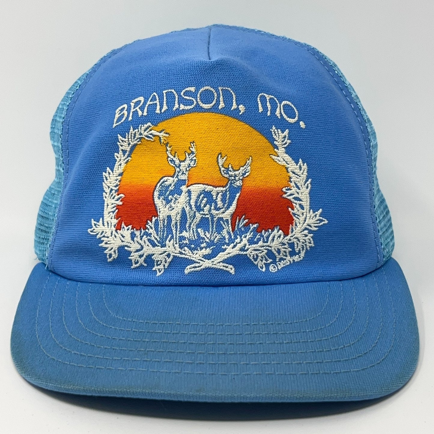 Blue vintage hat featuring Branson Missouri embroidery with deer and sunset design, front view