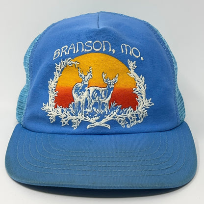 Blue vintage hat featuring Branson Missouri embroidery with deer and sunset design, front view