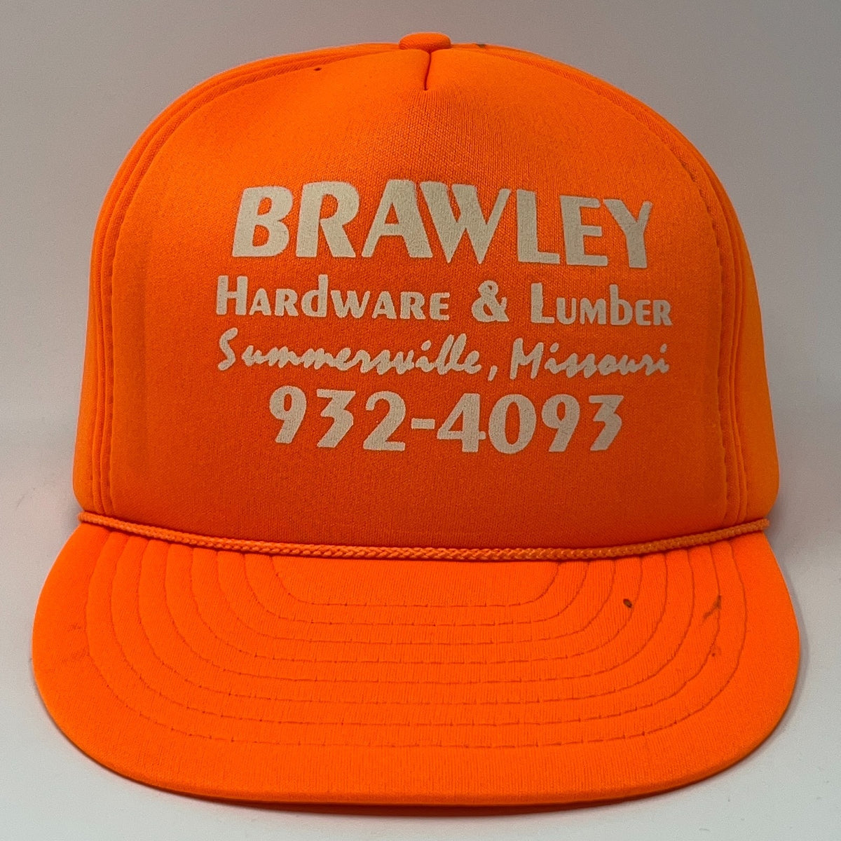 Vintage orange snapback cap featuring Brawley Hardware logo and contact information