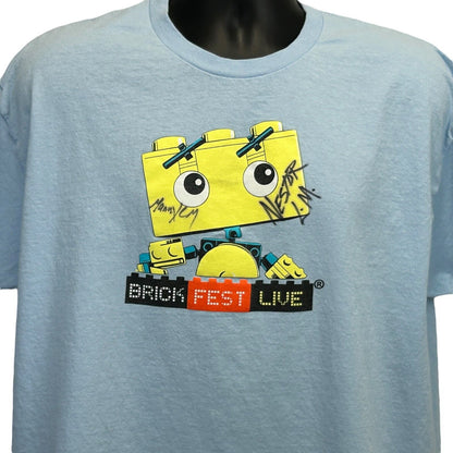 Light blue Gildan T-Shirt featuring a playful graphic of a brick character with 'Brick Fest Live' text and signatures