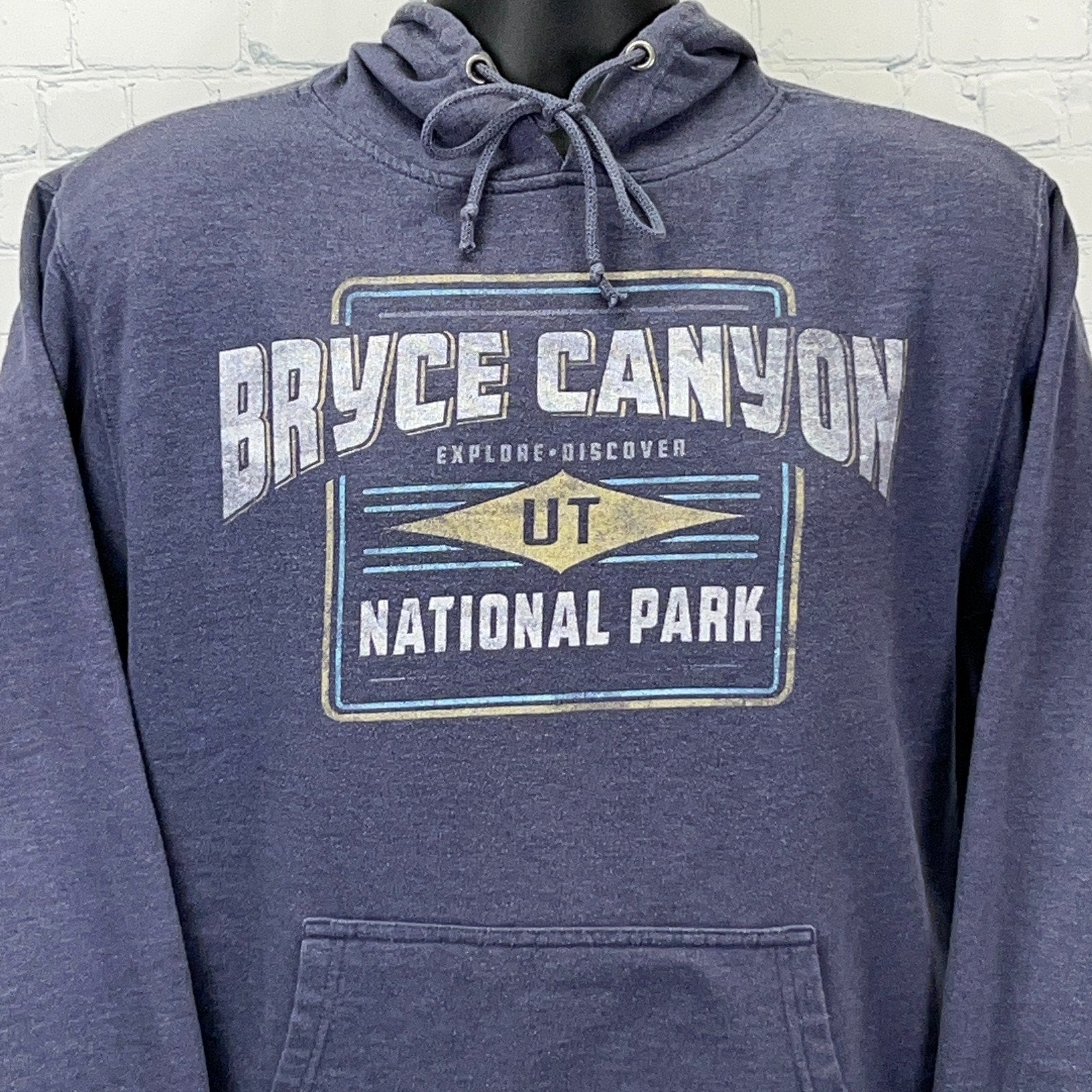 Delta Bryce Canyon hoodie in navy with Explore Discover graphic, featuring a front pocket and drawstring hood.