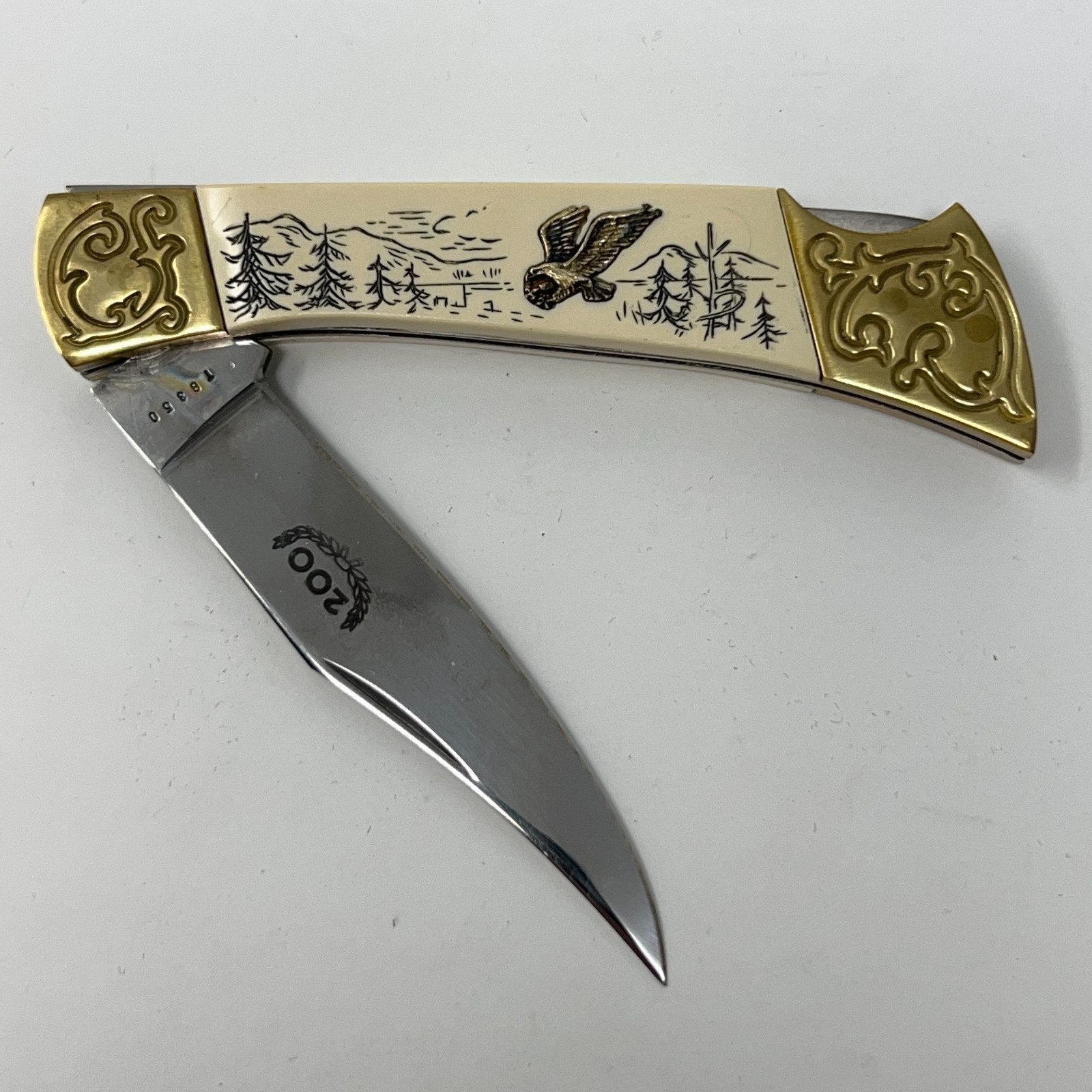 American International Mint pocket knife with a Bald Eagle design, brass handle and stainless steel blade