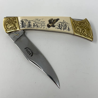 American International Mint pocket knife with a Bald Eagle design, brass handle and stainless steel blade