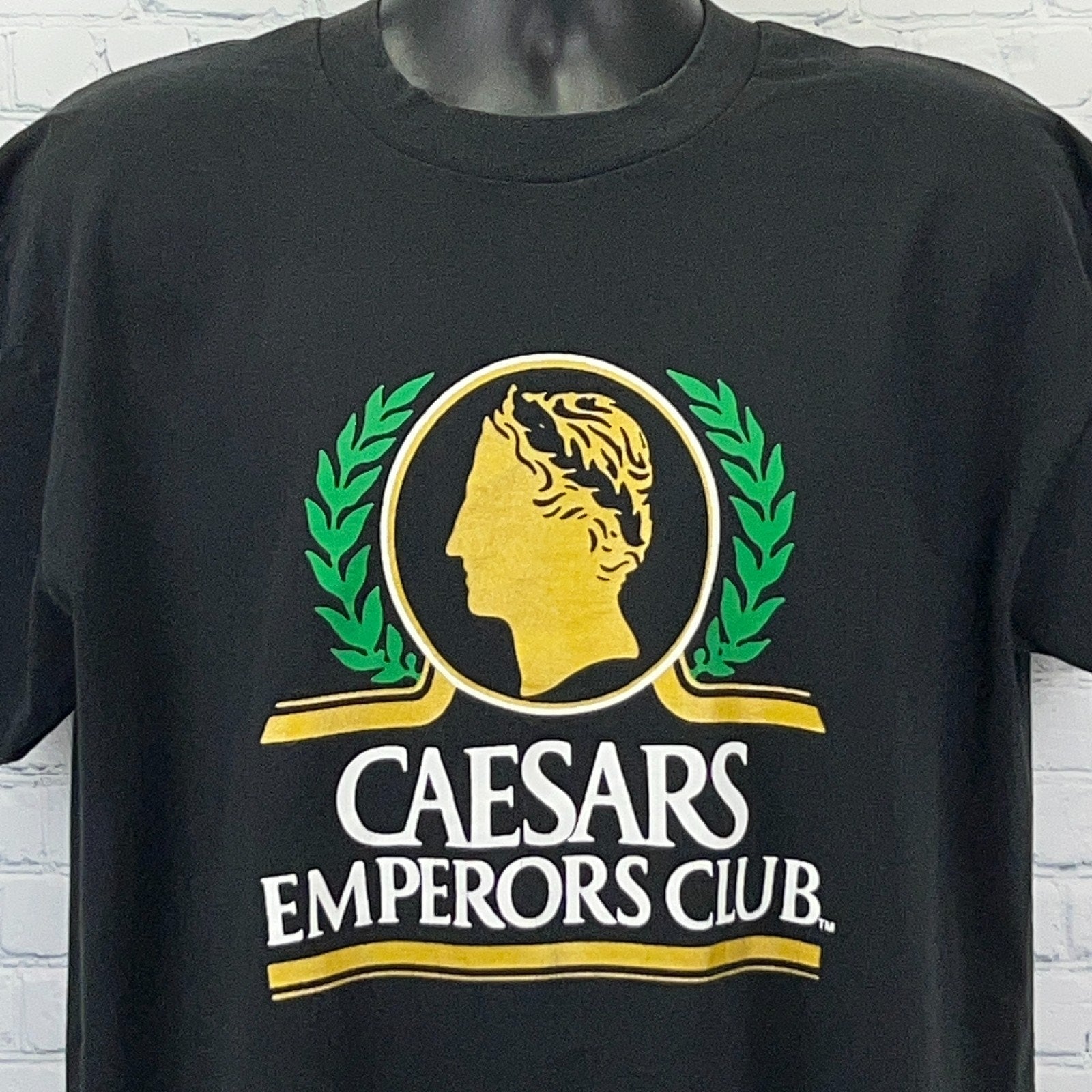 Black Fruit of the Loom T-shirt featuring Caesars Palace logo in yellow and green on the front