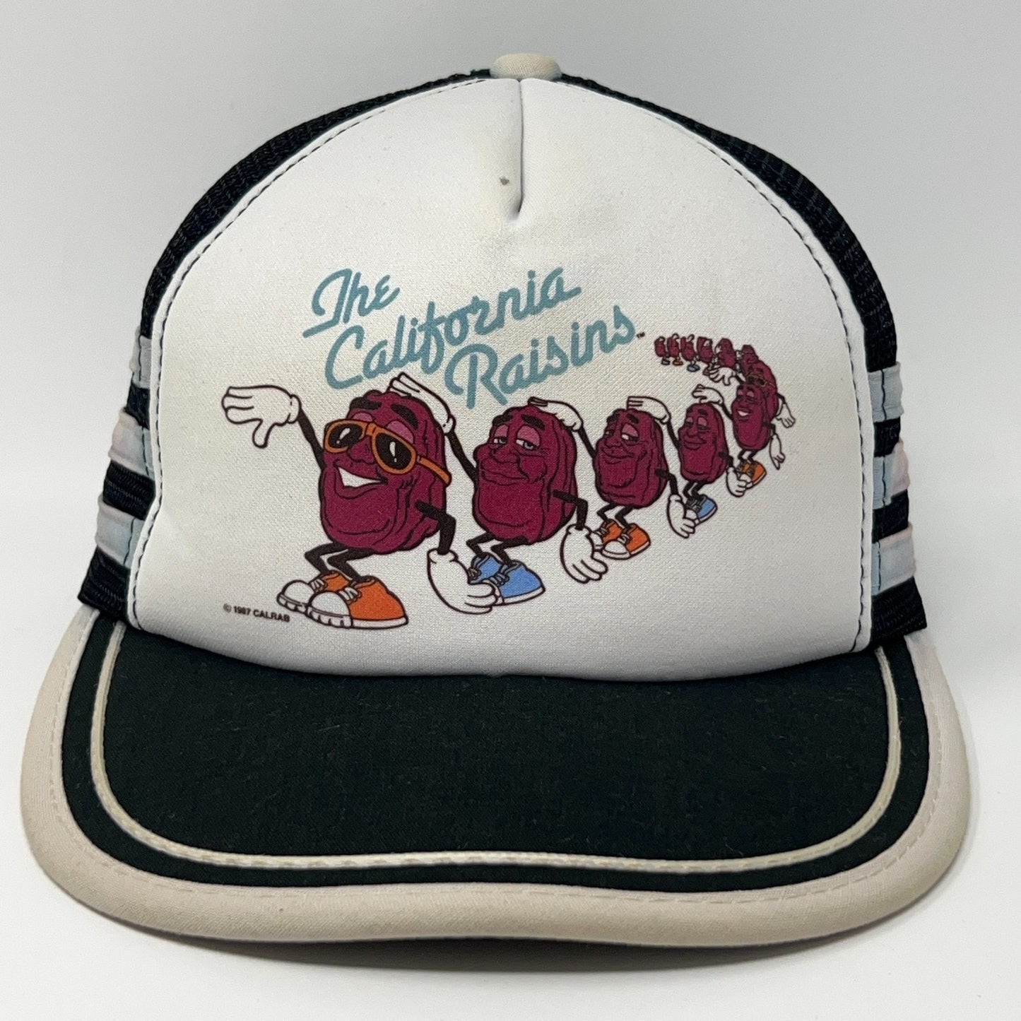 Vintage California Raisins Hat in white and black with front graphics of animated raisins in sunglasses