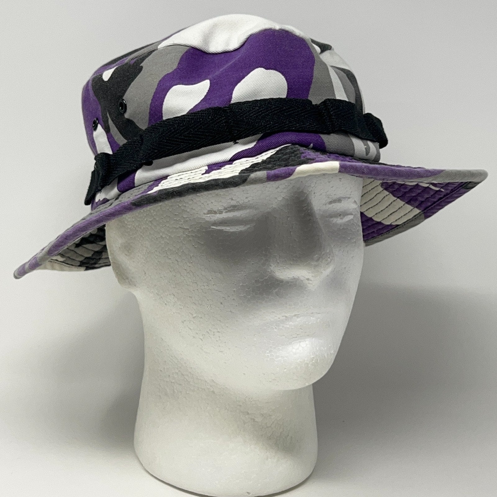 Front view of Unbranded Camouflage Bucket Hat in purple and gray with black adjustable strap and wide brim