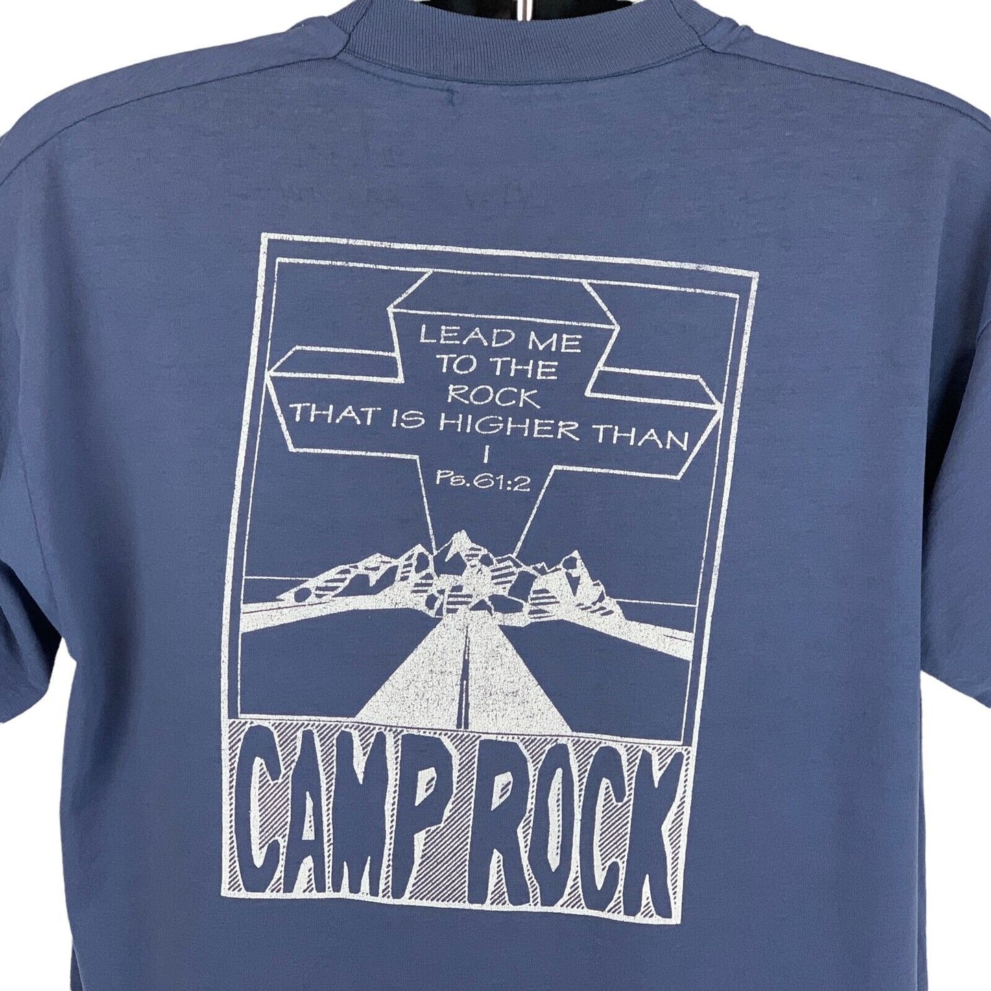 Back view of blue Christian T-shirt featuring a rock graphic and inspirational text.