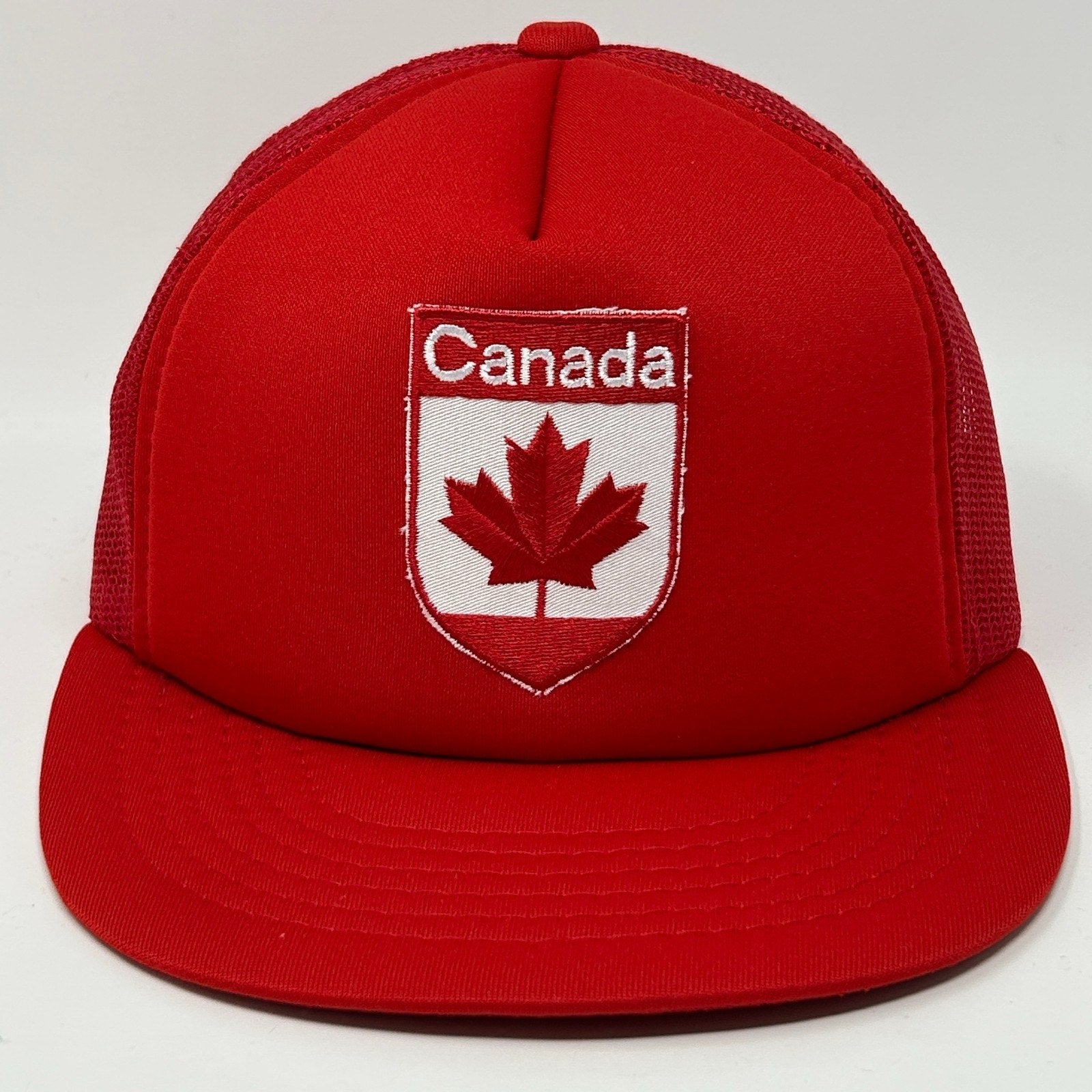 Red Canada Hat featuring embroidered maple leaf logo and adjustable snapback design