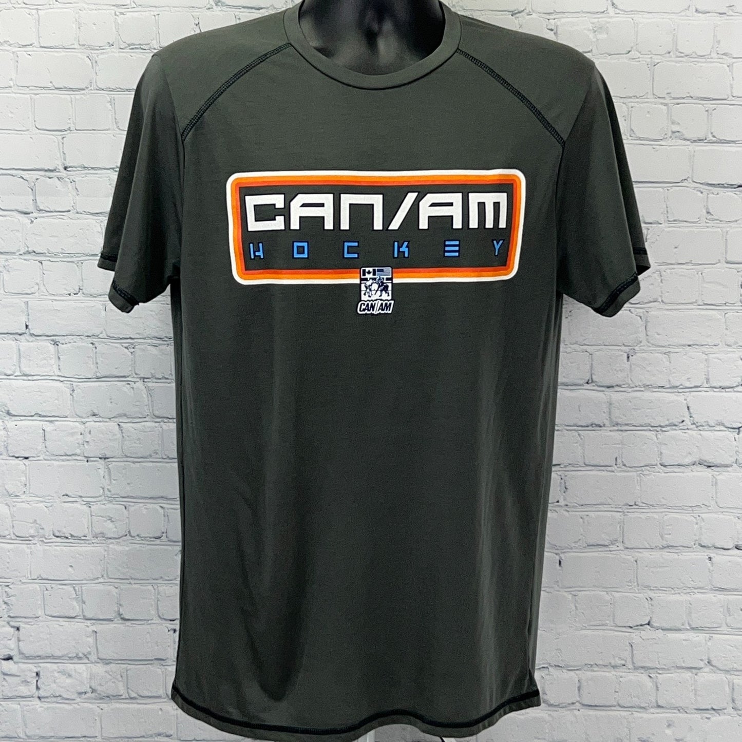 Men's dark green CAN/AM Hockey t-shirt with logo in front view and bold graphic design