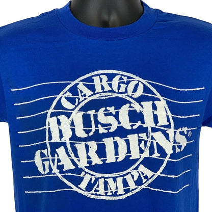 Front view of blue T-shirt featuring white Busch Gardens Tampa logo with 'Cargo' detail