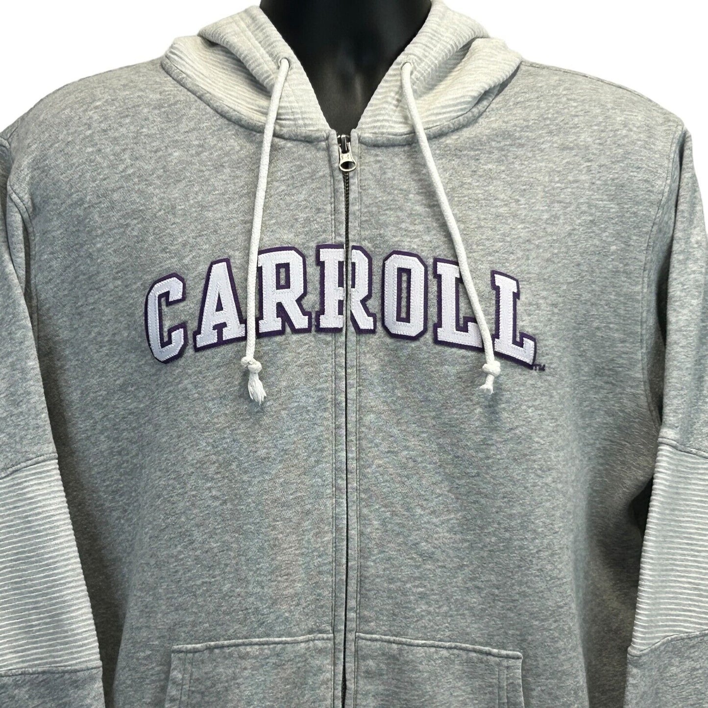 Grey Under Armour hoodie featuring Carroll College Saints logo, front view with zip closure and side pockets