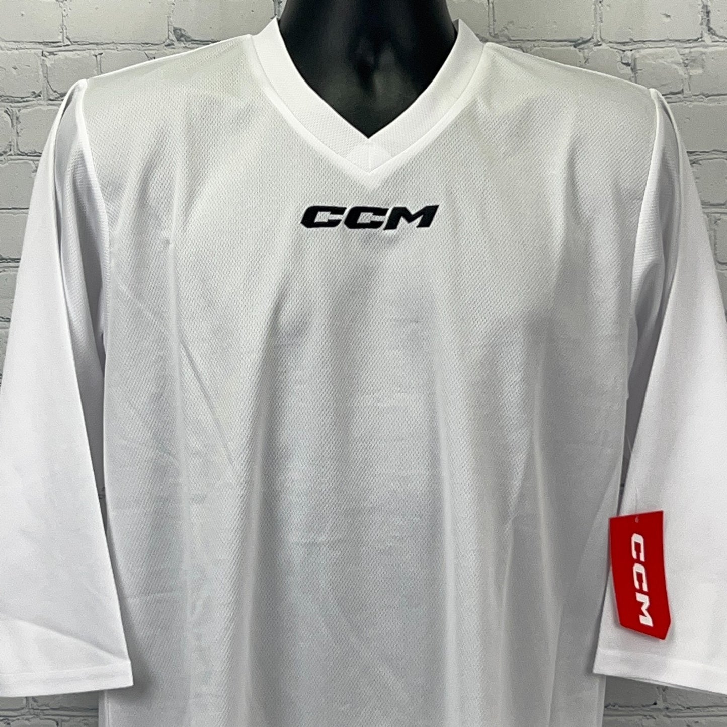 White CCM Long Sleeve Jersey with V-Neck, Front View, featuring logo on chest and sleeve