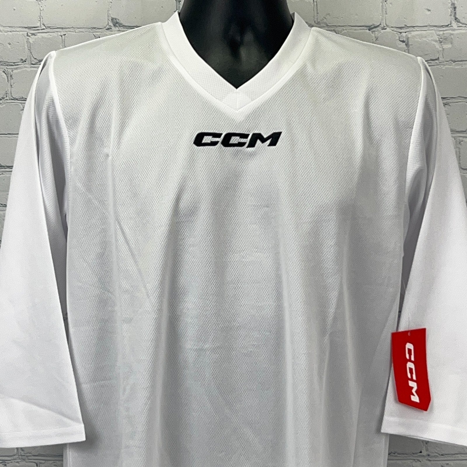 White CCM Long Sleeve Jersey with V-Neck, Front View, featuring logo on chest and sleeve