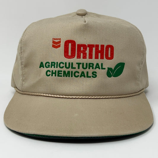 Beige Chevron Ortho baseball cap with green logo text and agricultural chemicals branding on the front