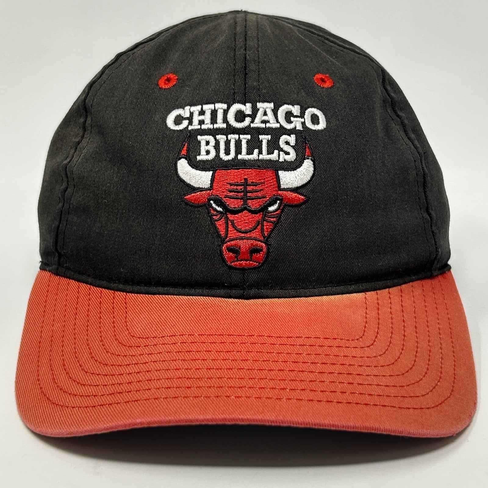 Men's Chicago Bulls Hat in black and orange with embroidered logo on front view
