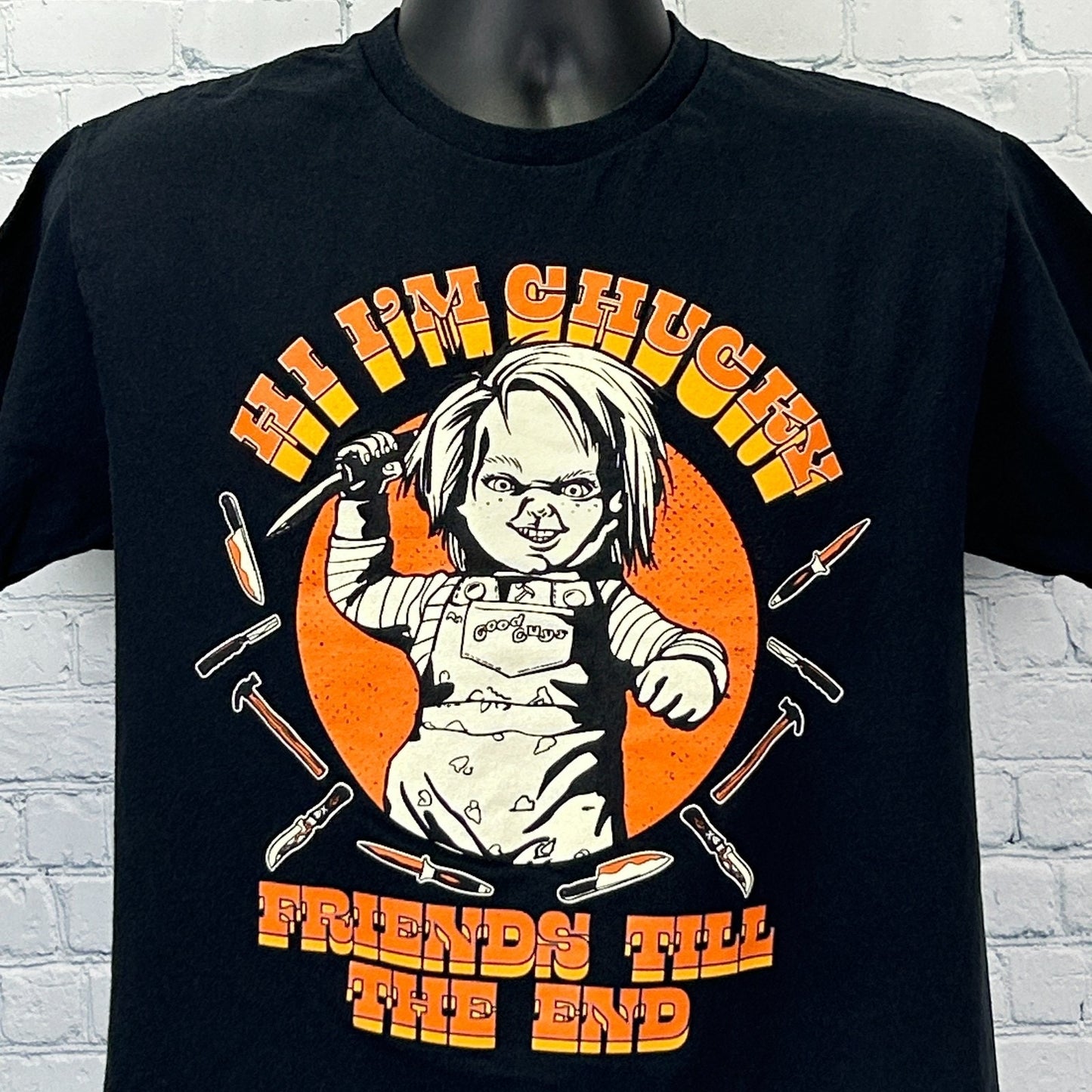 Black Chucky T Shirt from Hybrid Apparel featuring a graphic of Chucky with a knife on the front
