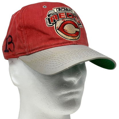 Front view of a red Starter Cincinnati Reds hat with a logo and gray brim for baseball fans.