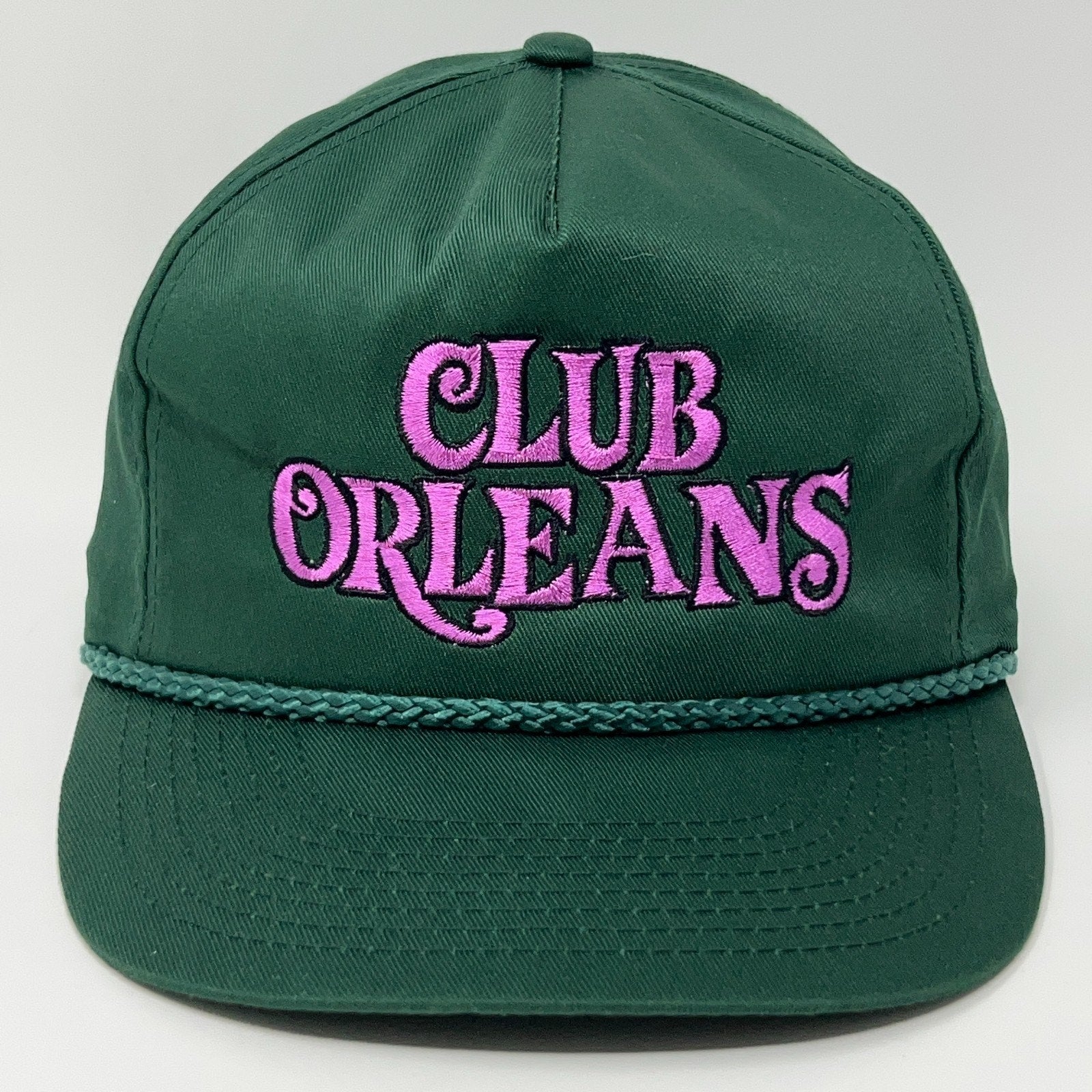 Vintage green hat with pink 'CLUB ORLEANS' embroidery and braided trim, ideal for Las Vegas fans