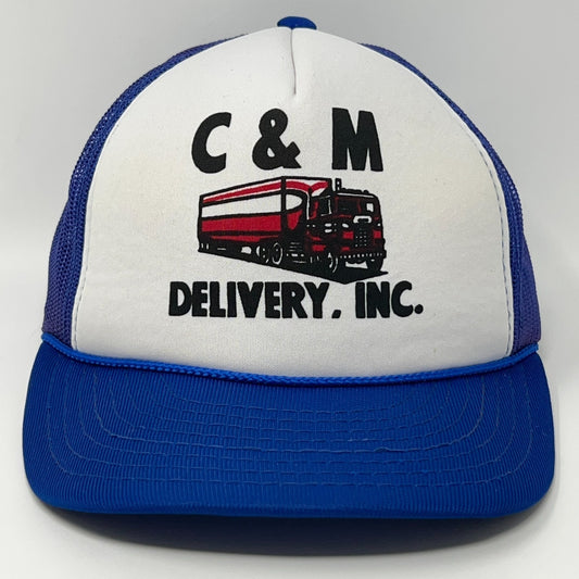 White and blue vintage trucker hat featuring C&M Delivery Inc logo with truck detail on the front