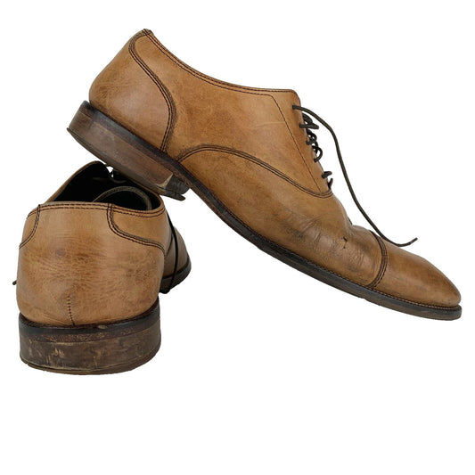 Cole Haan Brown Leather Dress Shoes in Size 10, showcasing a classic front view with detailed lacing.