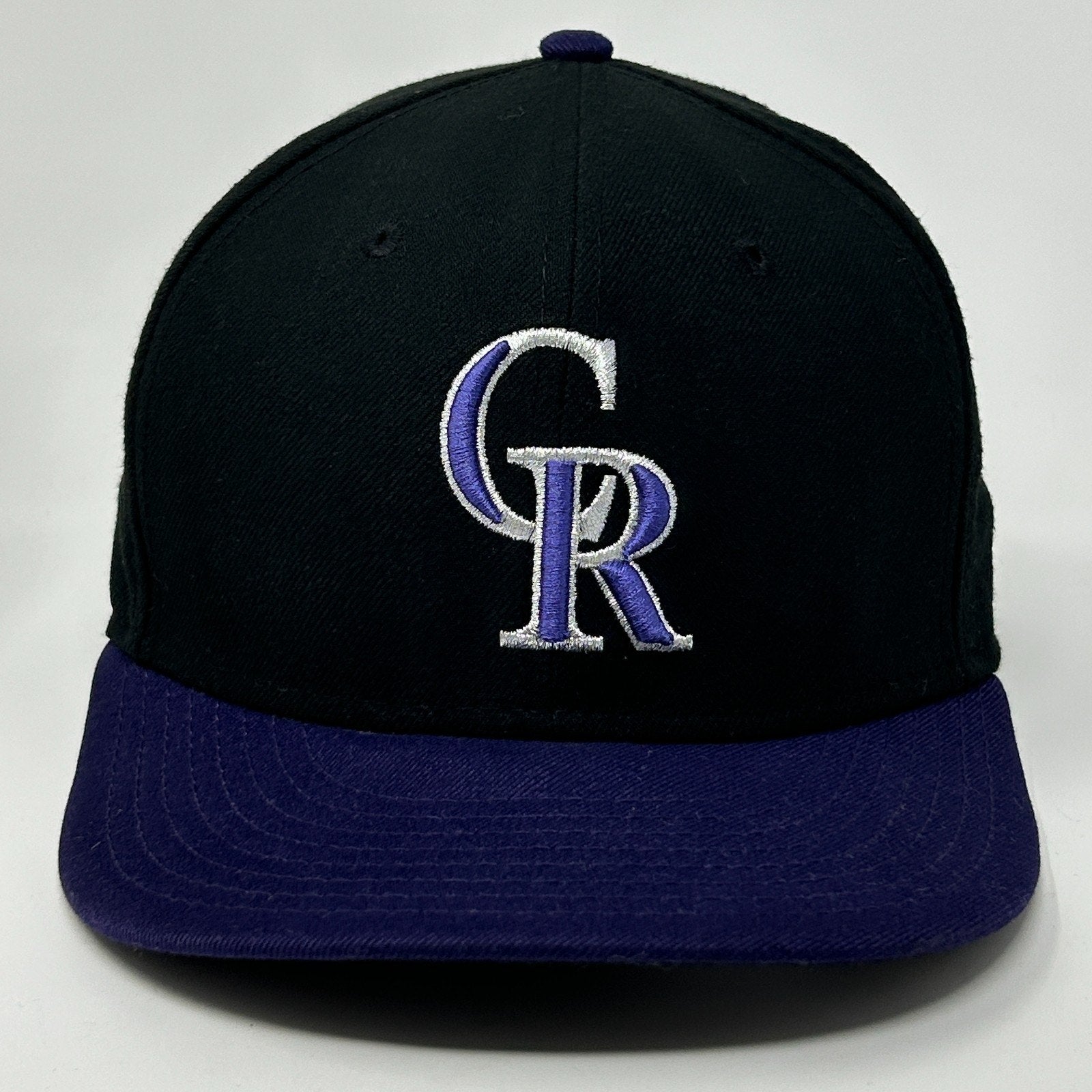 Front view of Colorado Rockies Hat in black and purple with embroidered logo detailing