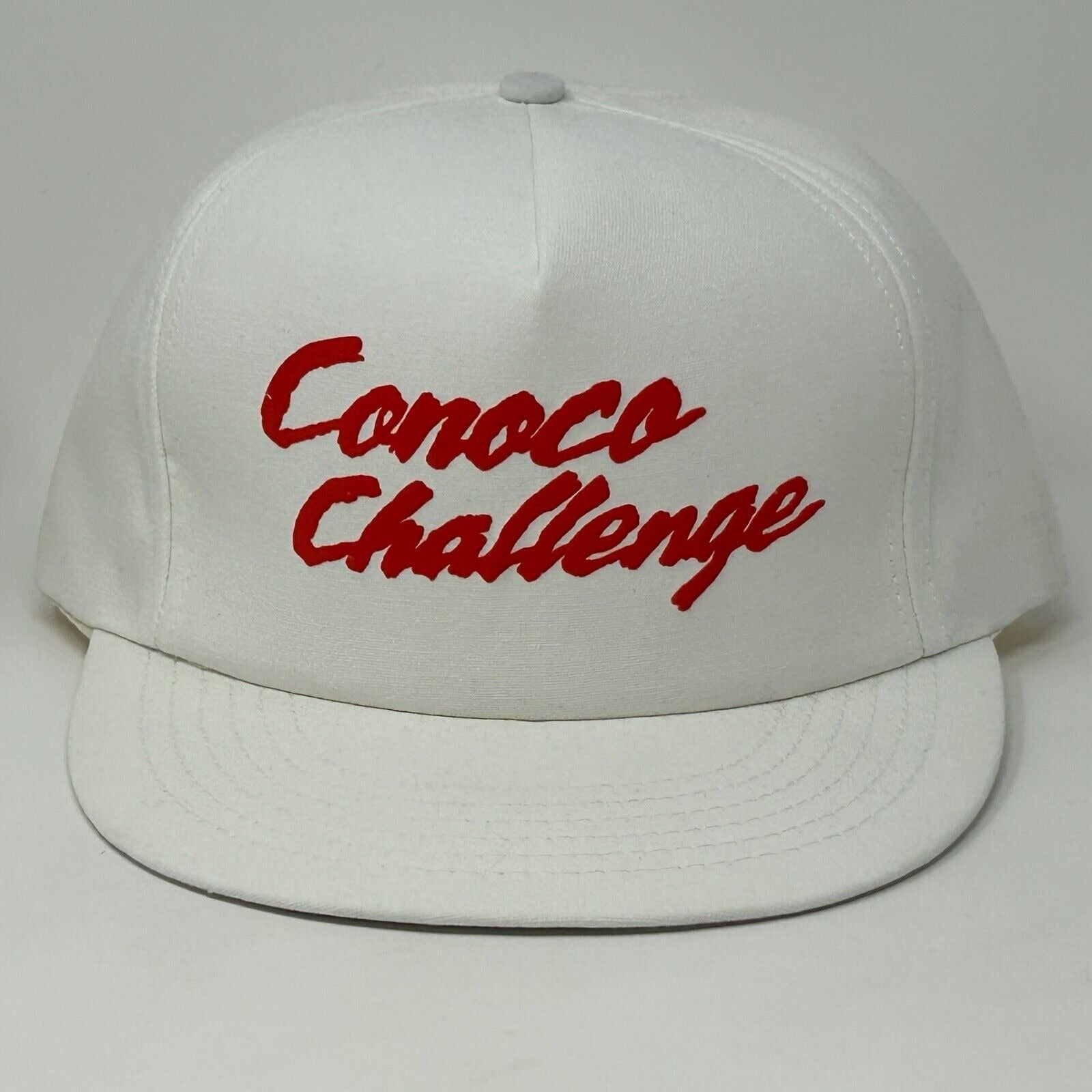 White Stylemaster hat with red Conoco Challenge logo, featuring a flat brim design for casual wear.