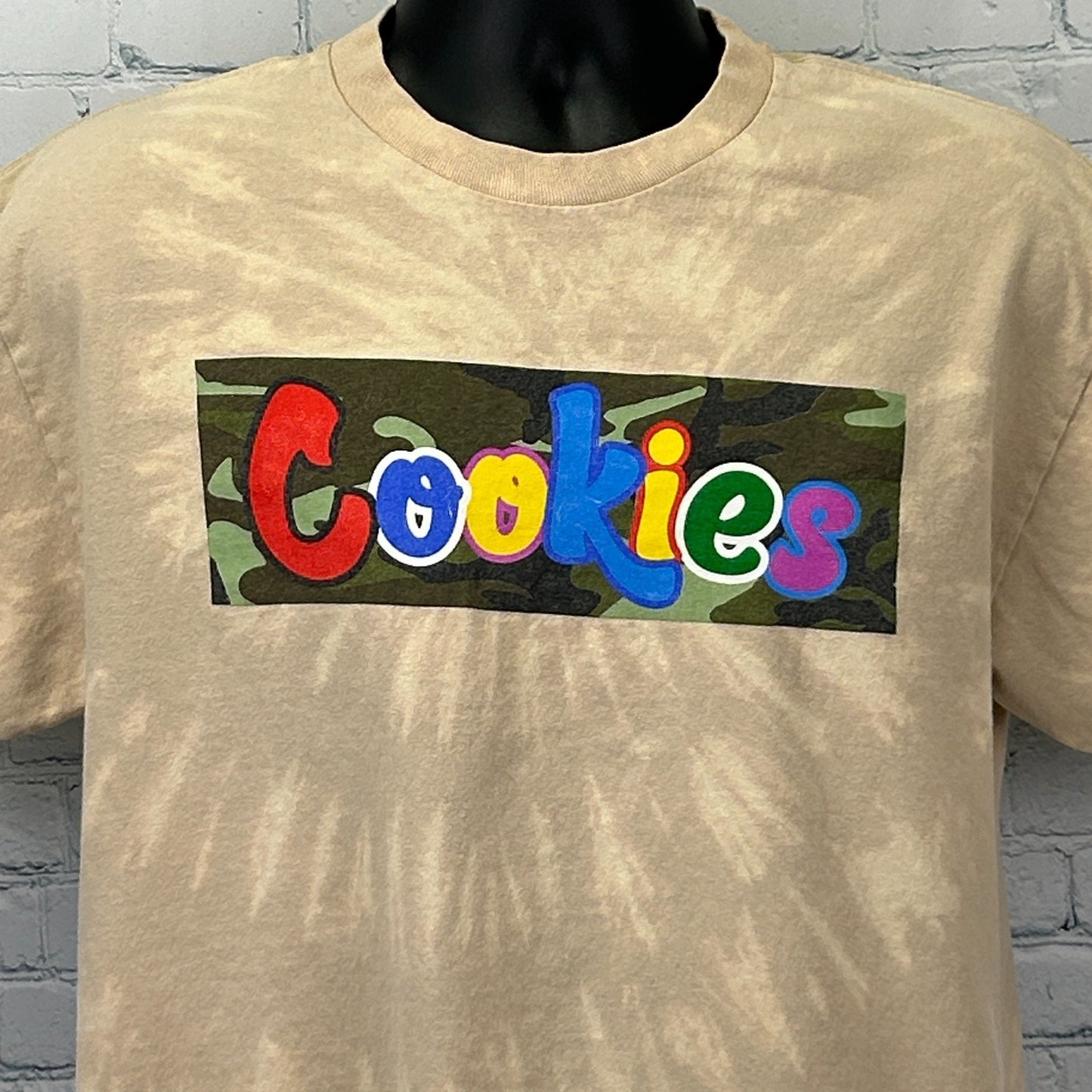 Beige Cookies Clothing T Shirt featuring multicolored logo box on the front
