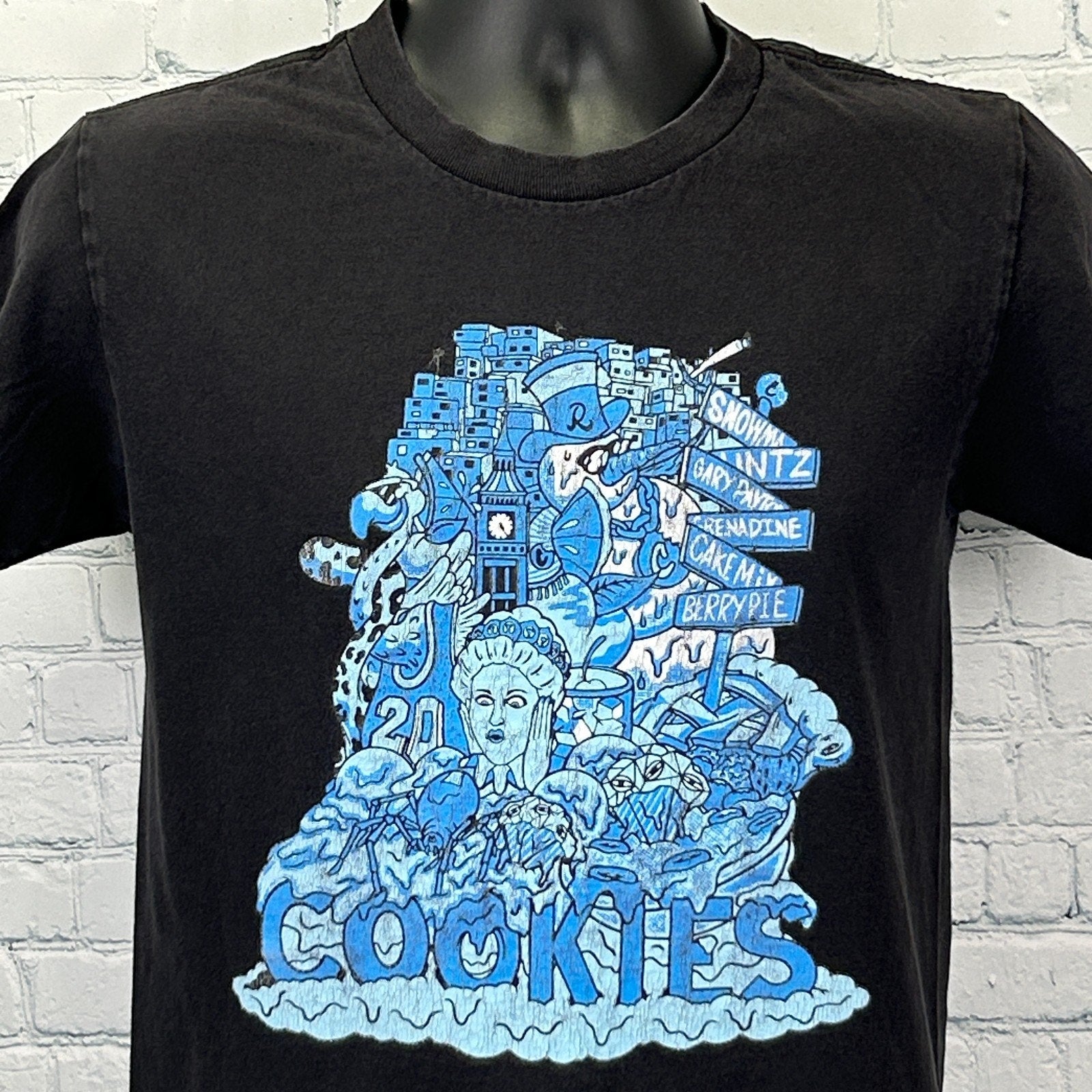 Front view of black Cookies T Shirt featuring blue graphic artwork and logo design
