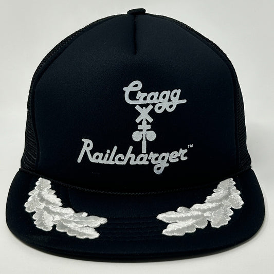 Front view of a Vintage Trucker Hat in black with white embroidered logos and leaf detail