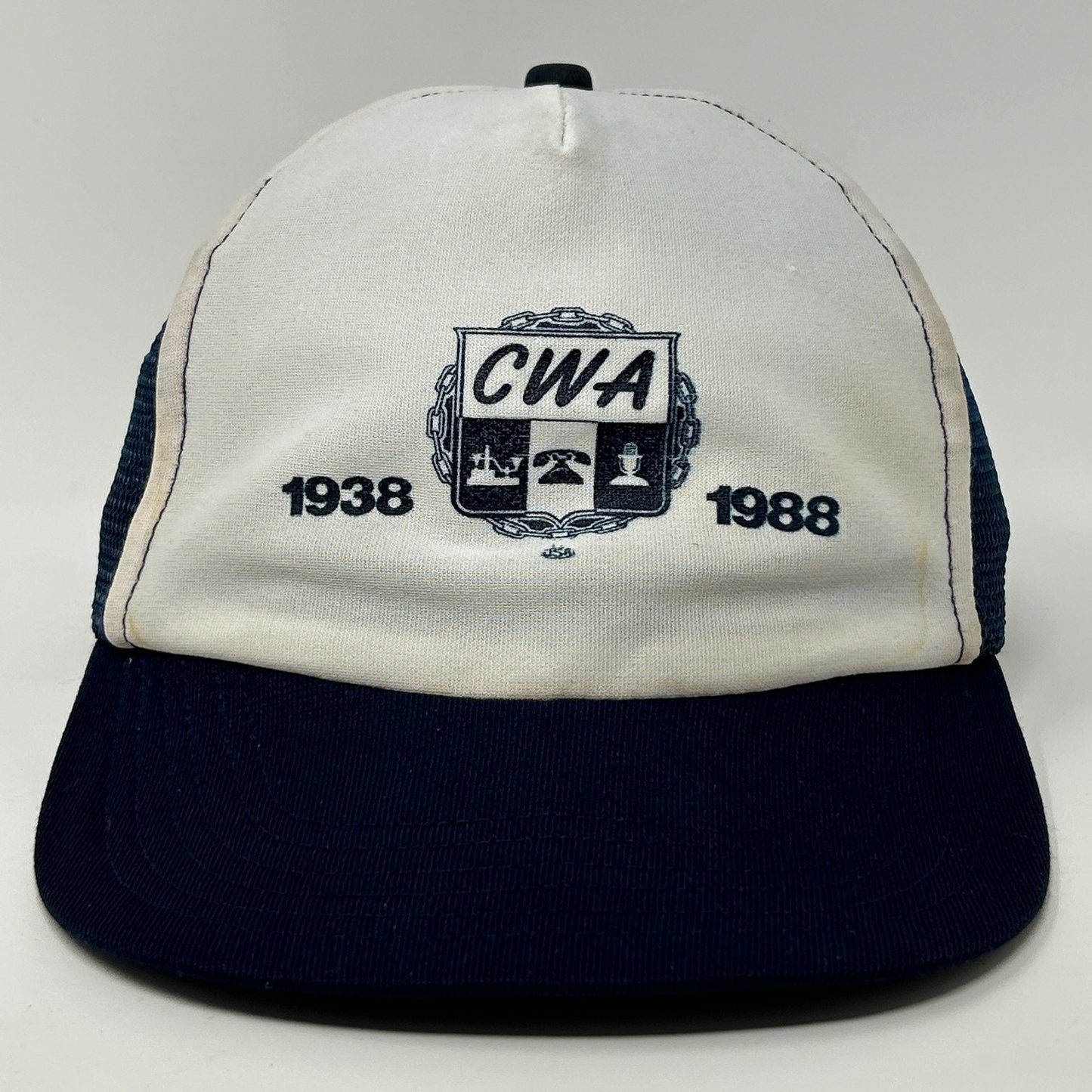 Vintage Trucker Hat in white and navy with CWA logo featuring 1938 and 1988 on the front