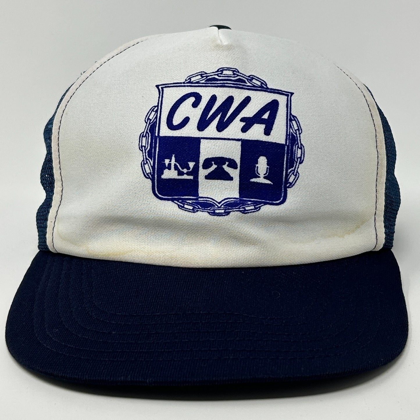 Vintage Trucker Hat in white and navy featuring CWA logo on the front