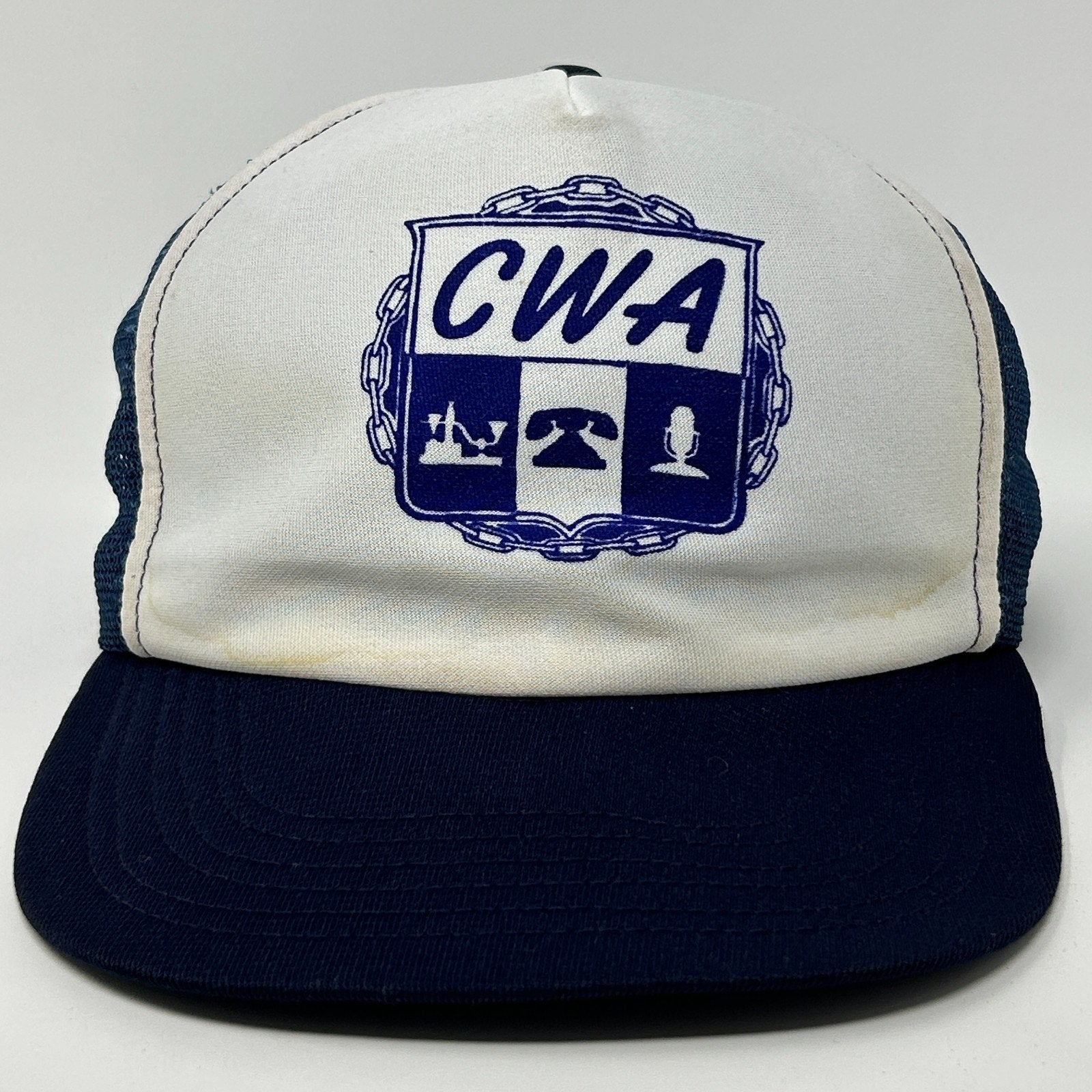 Vintage Trucker Hat in white and navy featuring CWA logo on the front