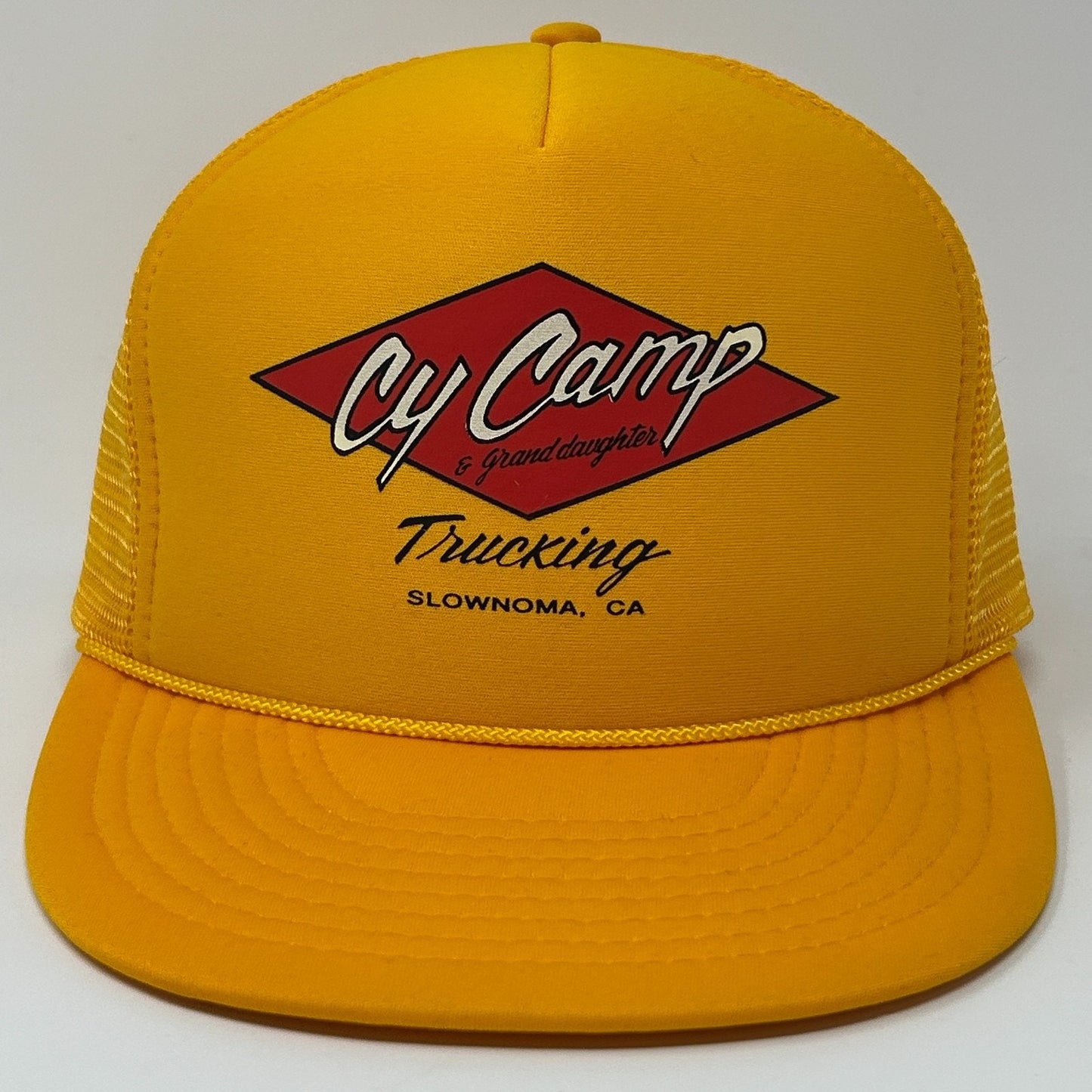 Vintage yellow Trucker Hat featuring Cy Camp Trucking logo on the front with mesh backing
