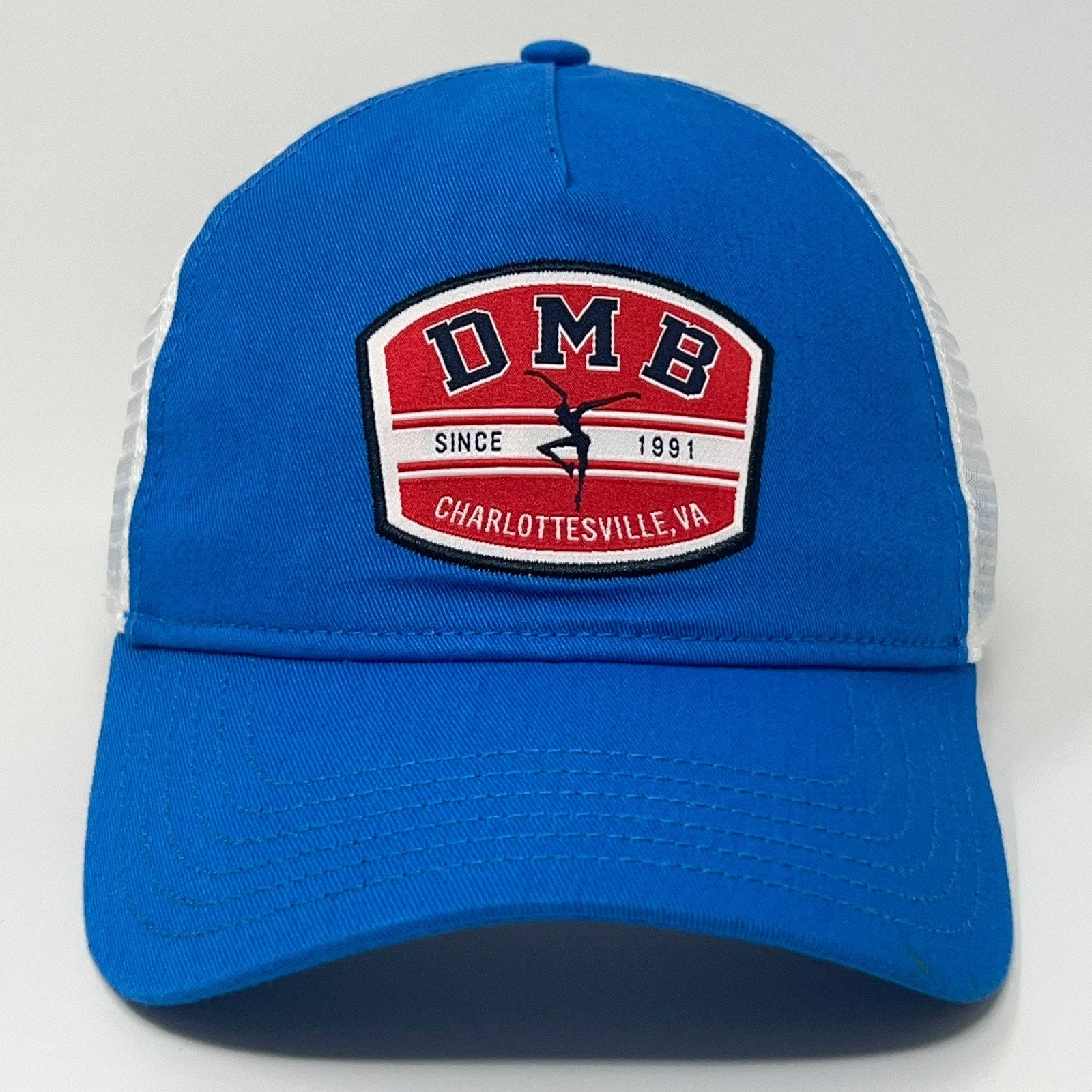 Bright blue Sportiqe cap with white mesh back and DMB logo, showing front detail for Dave Matthews Band fans