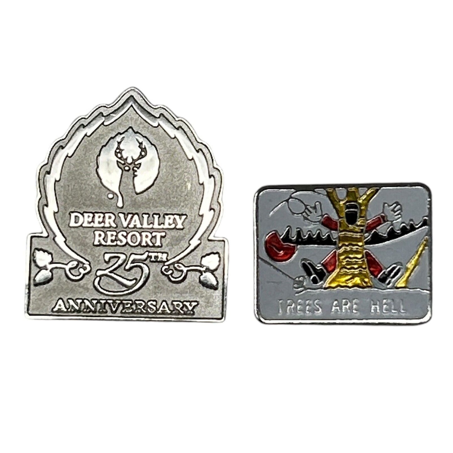Two skiing-themed pins: a silver Deer Valley Resort 25th Anniversary pin and a colorful Trees Are Hell pin