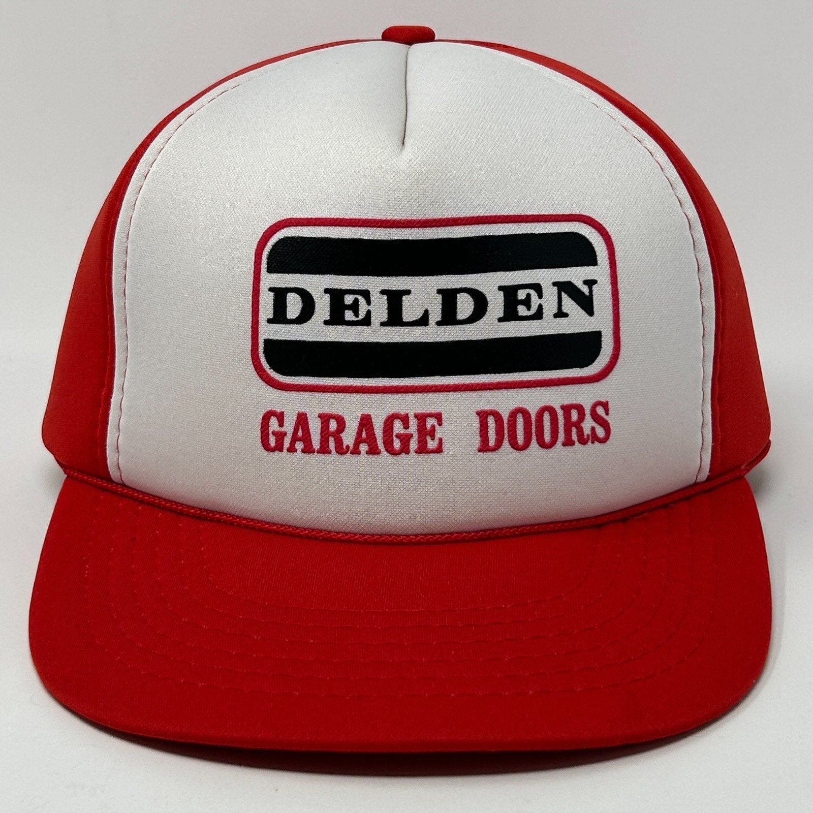 Red Vintage Hat with white front panel and Delden Garage Doors logo in black and red