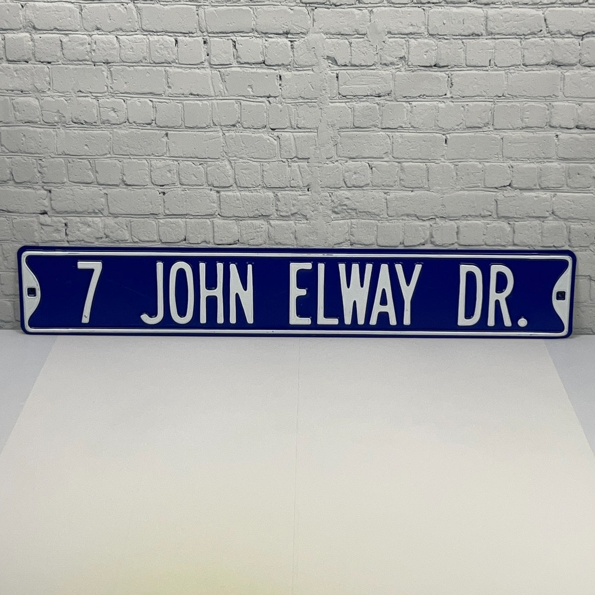 Denver Broncos street sign with blue background and white lettering for John Elway Drive