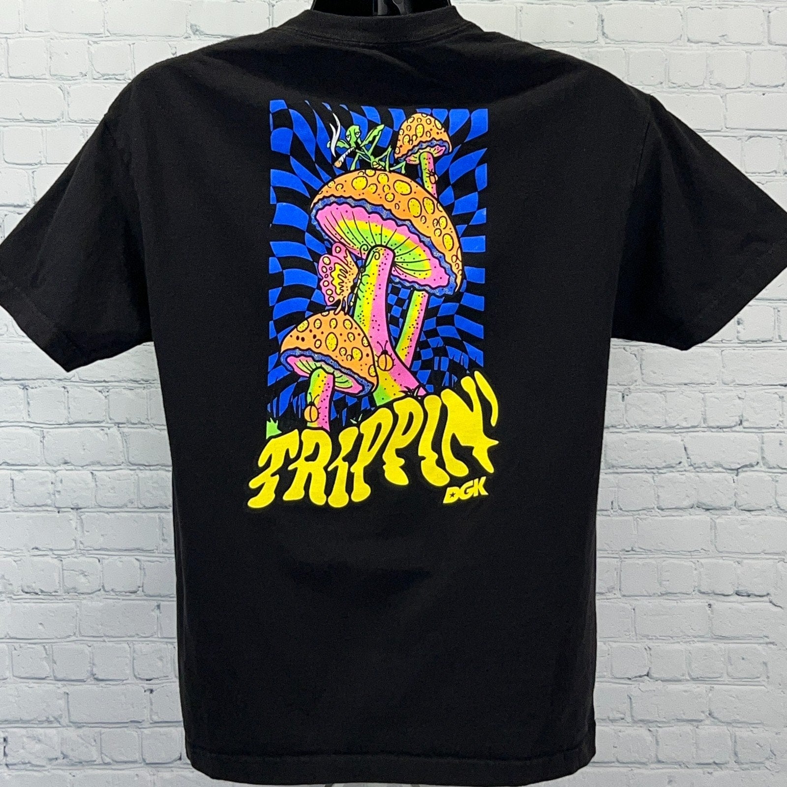Black DGK T-shirt featuring vibrant mushroom graphic and 'Trippin' text on back