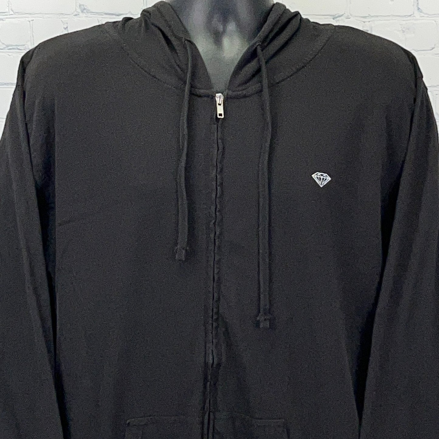 Black zip-up hoodie from Diamond Supply Co. featuring a small diamond logo on the chest, front view.