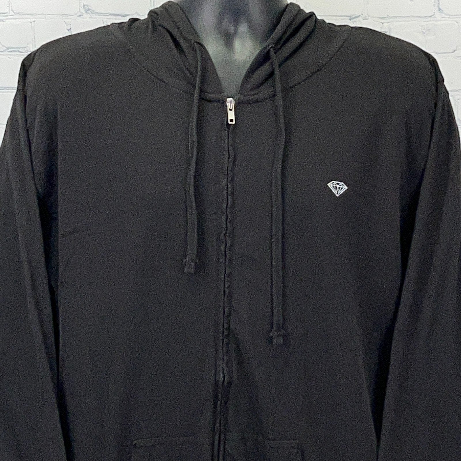 Black zip-up hoodie from Diamond Supply Co. featuring a small diamond logo on the chest, front view.