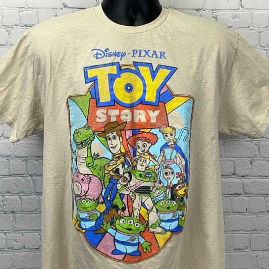 Cream Disney Pixar Toy Story T-shirt featuring colorful characters in a front view design