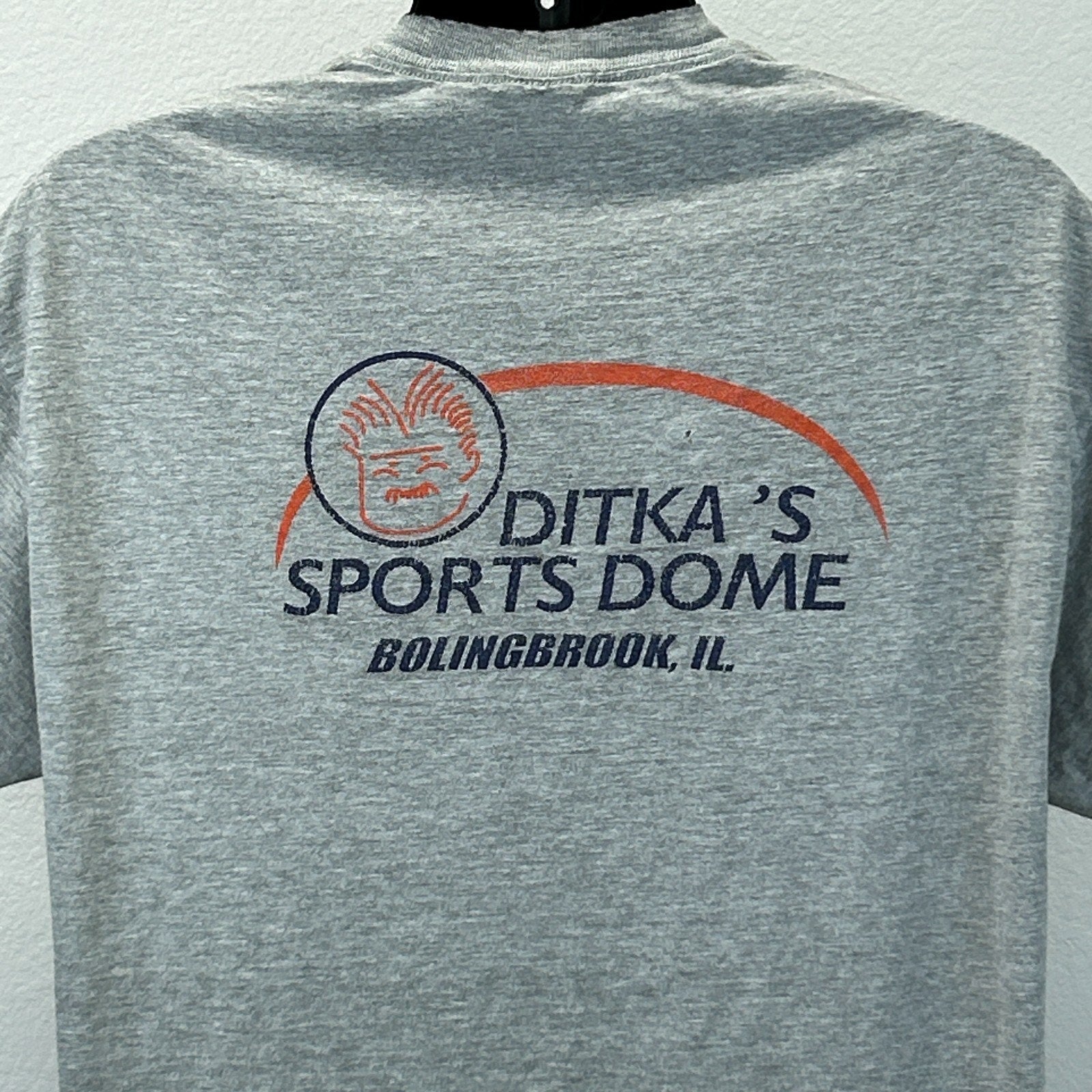 Back view of Hanes gray T-shirt featuring Mike Ditka's Sports Dome logo in Bolingbrook, IL